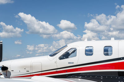 Airplane on airport runway against sky