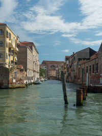 Canal passing through buildings in city