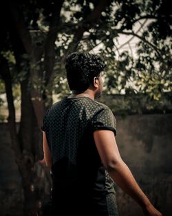 Side view of young woman standing outdoors