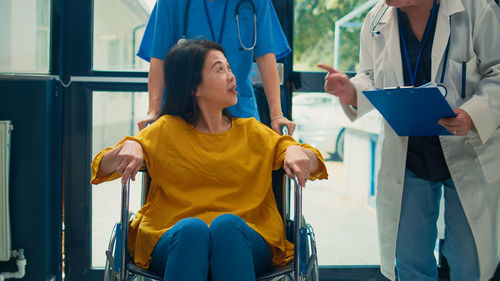 Portrait of woman sitting on wheelchair