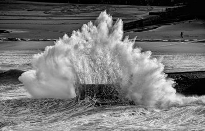 Panoramic view of waves splashing against sky