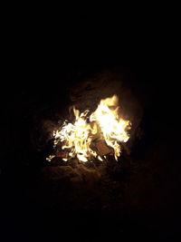 Close-up of bonfire on field at night