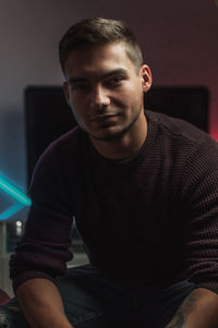 Portrait of young man sitting at home