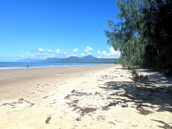 Scenic view of beach against blue sky