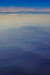 Scenic view of sea against dramatic sky during sunset