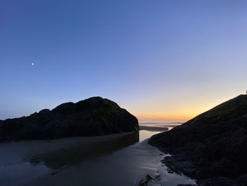 Scenic view of sea against clear sky during sunset