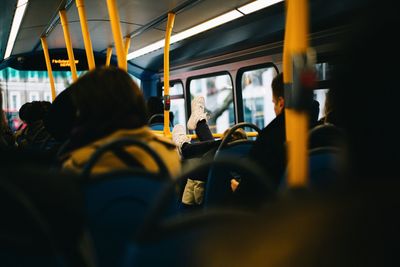 Rear view of people traveling in train