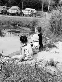 Girl and woman sitting on grass