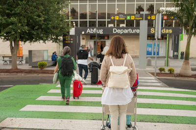 Rear view of woman walking on street