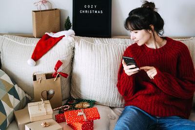 Rear view of woman using phone