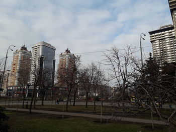 Low angle view of trees and buildings against sky