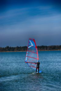 Man in water against sky