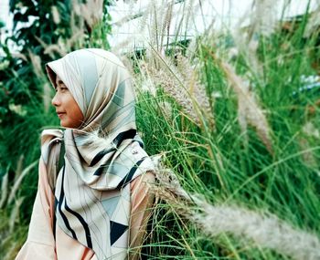 Side view of woman standing on field