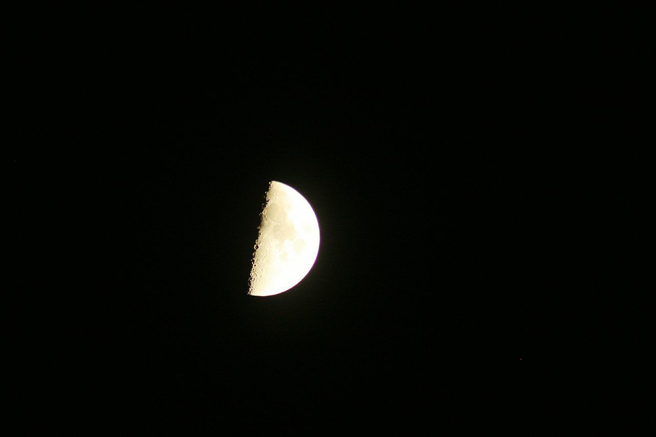 LOW ANGLE VIEW OF MOON AGAINST DARK SKY