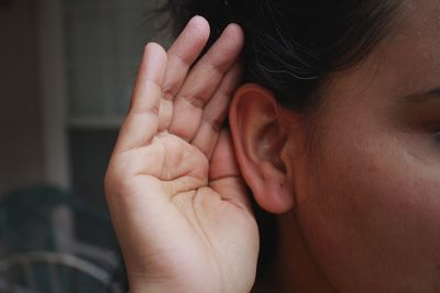 Cropped image of woman listening