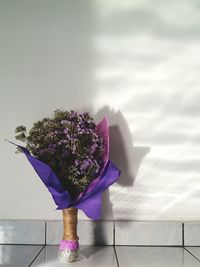 Close-up of flower vase on table against sky