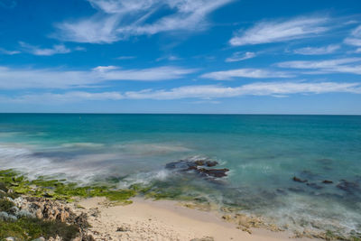 Scenic view of sea against blue sky