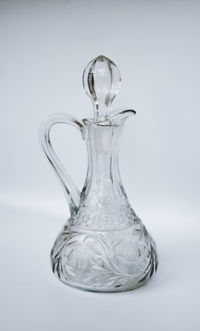 Close-up of glass jar against white background