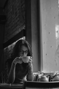 Woman sitting on table at cafe