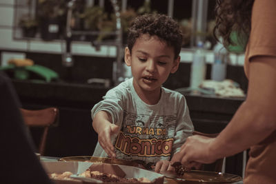 Portrait of young man preparing food