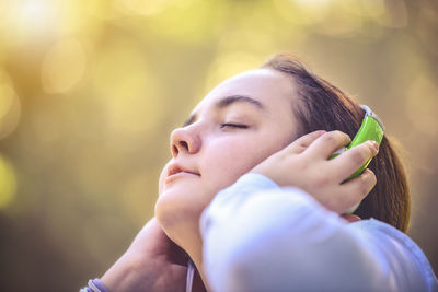 Close-up of woman listening to music