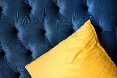 Close-up of yellow pillow on sofa