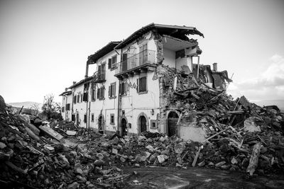 Low angle view of abandoned house against sky