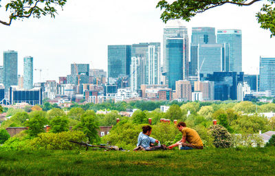 Rear view of woman sitting on bench in park