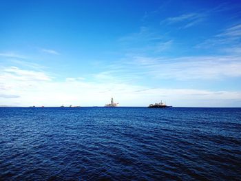 Scenic view of sea against blue sky