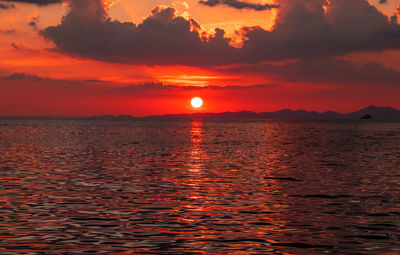 Scenic view of sea against romantic sky at sunset