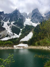 Scenic view of lake and mountains against sky