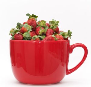 Close-up of fruits in bowl against white background