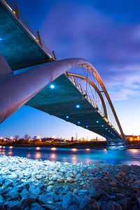 Low angle view of bridge over river at night