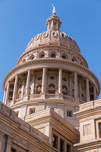 Low angle view of historic building against blue sky