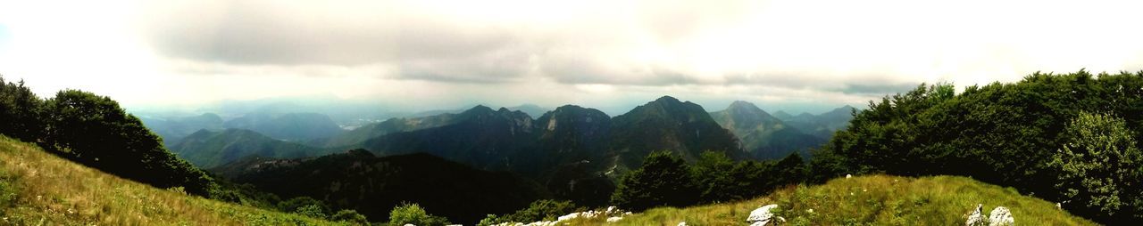 Panoramic view of mountains against cloudy sky