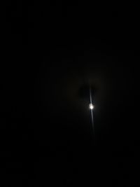 Low angle view of illuminated lights against clear sky at night