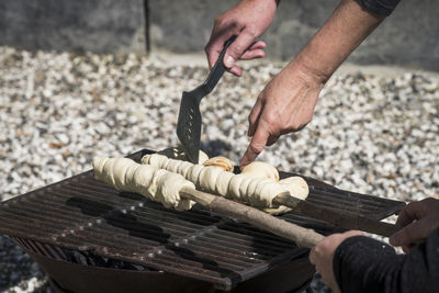 Close-up of person preparing food on grill