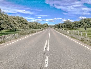 Road passing through landscape against sky