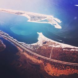 Aerial view of sea and mountains against sky