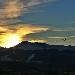 Scenic view of mountains against cloudy sky