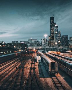 High angle view of trains against sky in city at dusk