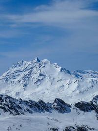 Scenic view of snowcapped mountains against sky