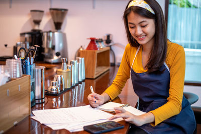 Portrait of young woman using laptop at home