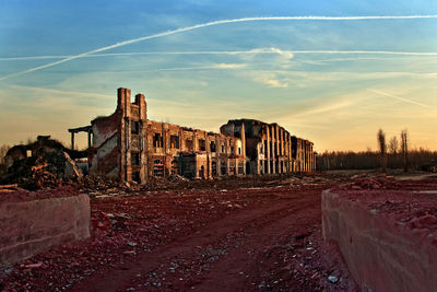 Old building against sky during sunset