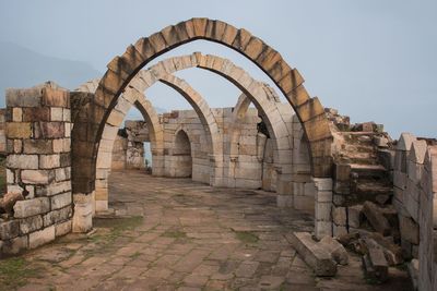 Low angle view of old ruins against sky