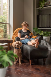 Man with dog sitting on floor