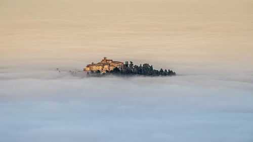 Italy january 2022, view of the village of piticchio di arcevia immersed in the fog, 