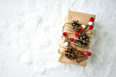 Zero waste christmas presents with decorations on white snow background. copy space. eco friendly