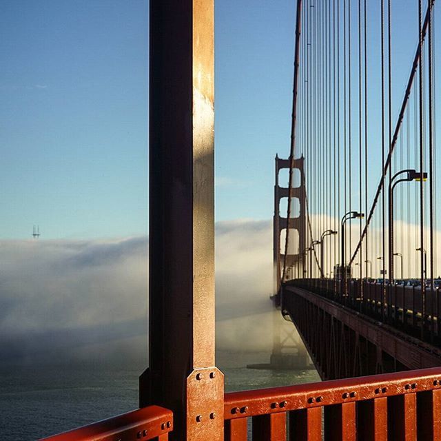 architecture, built structure, bridge - man made structure, connection, engineering, transportation, water, bridge, railing, suspension bridge, river, sky, travel destinations, sea, travel, architectural column, metal, day, famous place, no people