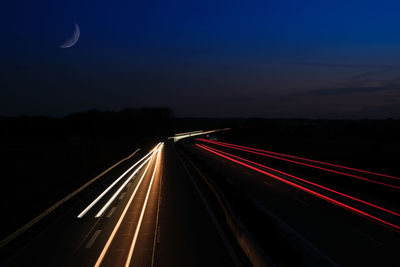 High angle view of light trails on highway at night